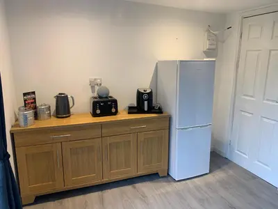 a kitchen with a white refrigerator and a wooden counter at Sunnyside guest house in Latchingdon and Snoreham