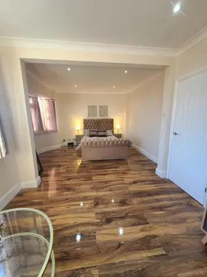 a large living room with a couch and wooden floors at One Bed and Bath in Rochford in Rochford