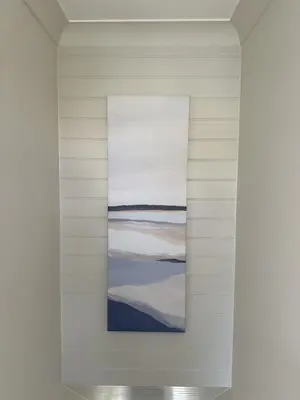 a painting hangs on a wall in a white room at Detached Luxury Coach House - Sky Sports Cinema - EVCharger in Colchester
