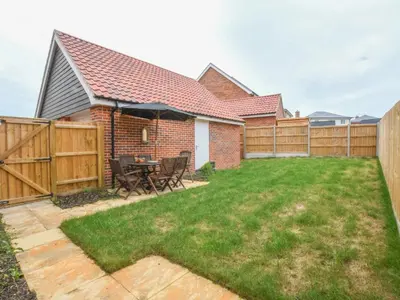 a backyard with a fence and a table and chairs at 51 Halesworth in Holton