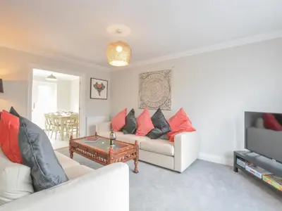 a living room with a couch and a table at 51 Halesworth in Holton