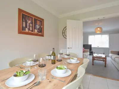 a dining room with a table with glasses of wine at 51 Halesworth in Holton