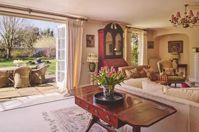 a living room with a couch and a table at Hockham Grange in Hockham