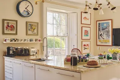 a kitchen with a counter and a clock on the wall at Hockham Grange in Hockham