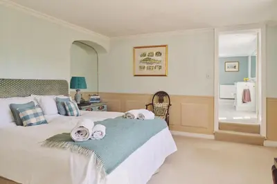 a bedroom with a bed with towels on it at Hockham Grange in Hockham