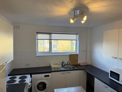 a small kitchen with a sink and a stove at 3 Bedroom Apartment in Rayleigh Town Centre with Balcony in Rayleigh