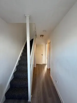 an empty hallway with stairs in a house at 3 Bedroom Apartment in Rayleigh Town Centre with Balcony in Rayleigh
