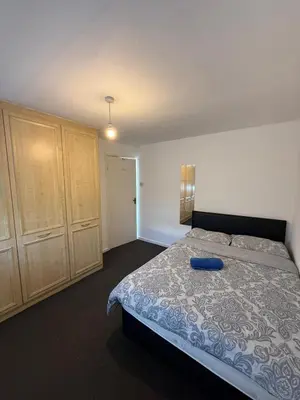 a bedroom with a bed with a blue frisbee on it at 3 Bedroom Apartment in Rayleigh Town Centre with Balcony in Rayleigh