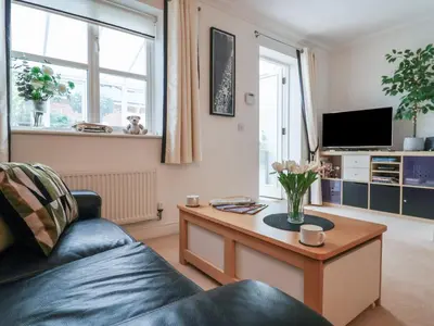 a living room with a couch and a coffee table at Bay Tree Cottage in Saxmundham