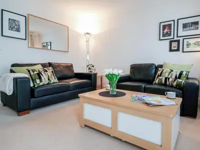 a living room with two couches and a coffee table at Bay Tree Cottage in Saxmundham