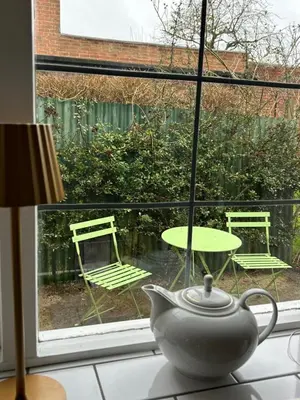 a tea pot sitting on a counter in front of a window at Victorian Woodbridge cottage in Melton