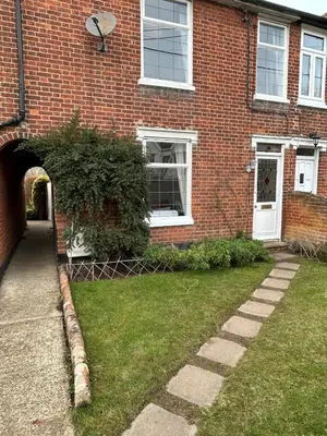 a brick house with an archway in the yard at Victorian Woodbridge cottage in Melton
