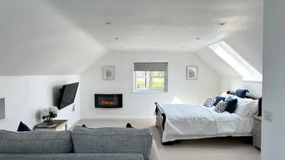 a living room with a bed and a couch at The Lodge in Felsted