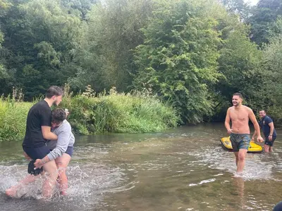a group of people in the water in a river at Riverside farm Yurt tent Hertford in Hertford