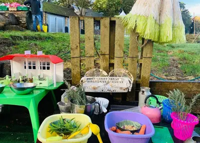 a garden with a table and a fence and some plants at Riverside farm Yurt tent Hertford in Hertford