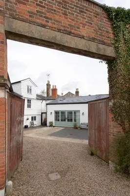 a brick building with an open garage door at Historic Old Stables in Bishops Stortford