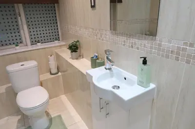 a bathroom with a white toilet and a sink at Stylish City-Centre Stay in Chelmsford