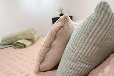 a bed with two pillows on top of it at Stylish City-Centre Stay in Chelmsford