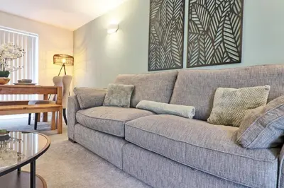 a living room with a couch and a table at Cozy Modern Home Basildon Long stay Contractors Sleeps 6 in Basildon
