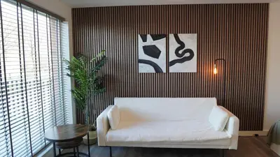 a living room with a white couch and a table at Cambridge Urban Suite in Cambridge