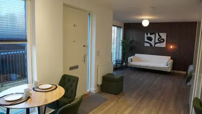a living room with a table and chairs and a couch at Cambridge Urban Suite in Cambridge