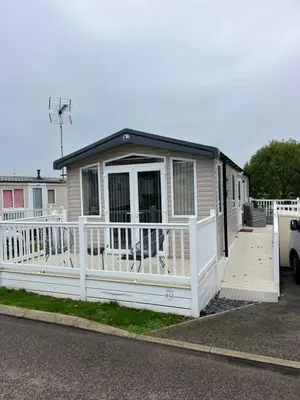 a house with a white fence and a porch at Mimosa holiday home in Little Clacton