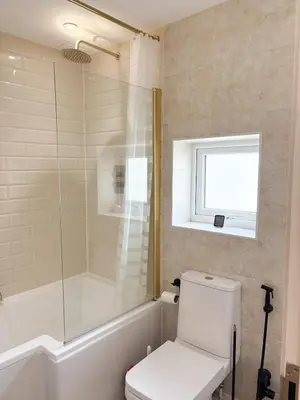 a bathroom with a white toilet and a shower at Home in Upminster in Upminster