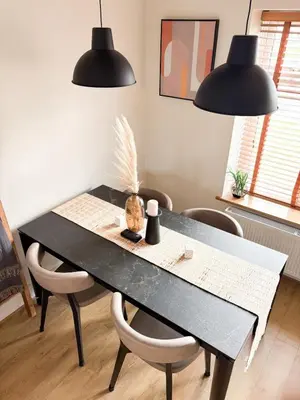 a black dining room table with chairs and two black lights at Home in Upminster in Upminster