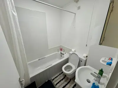 a bathroom with a tub and a toilet and a sink at Central One-Bedroom Flat - Free Private Parking in Chesterton