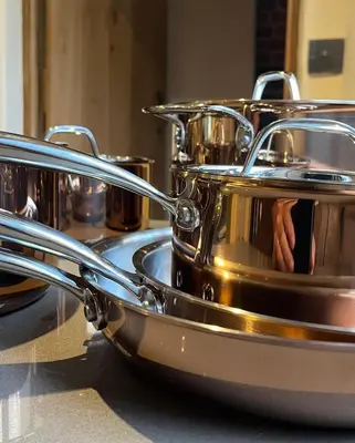 a group of silver pots sitting on a counter at Park Farm in Thornham Magna