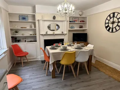 a dining room with a table and chairs at The Tudors Modern 3-Bed Home with Fast WiFi, Private Drive & Near Town Center in Chelmsford