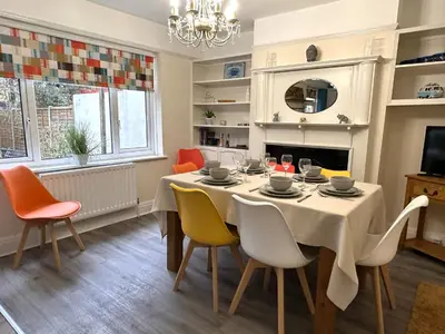 a dining room with a table and chairs at The Tudors Modern 3-Bed Home with Fast WiFi, Private Drive & Near Town Center in Chelmsford