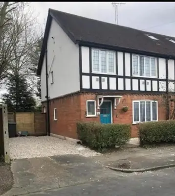 a white and red house with a blue door at The Tudors Modern 3-Bed Home with Fast WiFi, Private Drive & Near Town Center in Chelmsford