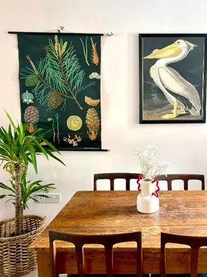a dining room with a wooden table with chairs at Hurrell Cottage in Cambridge