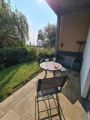 a table and two chairs sitting on a patio at Alices’s Beachside Haven in Harwich