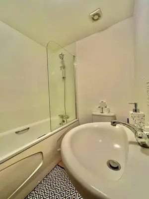 a white bathroom with a shower and a sink at 4 Bedroom House - DISC0UNTS - Parking, Contractors, Group, Family in Colchester