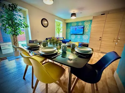 a dining room with a table and yellow chairs at 5 Bedroom House - DISC0UNTS - Parking, Contractors, Crew, Group, Family in Colchester