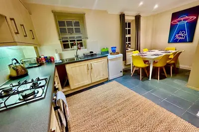 a kitchen with a table and a dining room at 5 Bedroom House - DISC0UNTS - Parking, Contractors, Group, Family in Colchester