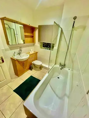 a bathroom with a tub and a toilet and a sink at 5 Bedroom House - DISC0UNTS - Parking, Contractors, Group, Family in Colchester