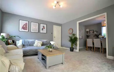 a living room with a couch and a table at Family home in Great Dunmow for up to 5 guests in Great Dunmow