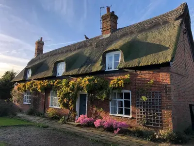a brick house with ivy on the side of it at The Old Cottage - Sudbourne, near Orford in Sudbourne