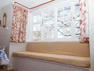 a window seat in a room with two windows at Holm Oak Lodge in Clacton-on-Sea