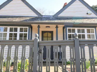 a white fence in front of a house at Holm Oak Lodge in Clacton-on-Sea