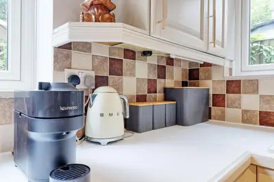 a kitchen counter with a coffee maker on the counter at Luxury 4-Bed Family Home in Epping with Parking by LMV Property in Epping