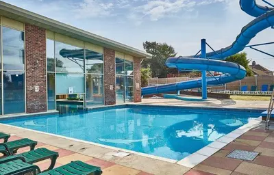 a swimming pool with a water slide in a house at Highfield Grange Holiday Park Clacton in Little Clacton