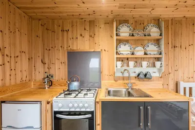 a kitchen with a stove and a sink at River Lodge, Aldeburgh in Aldeburgh