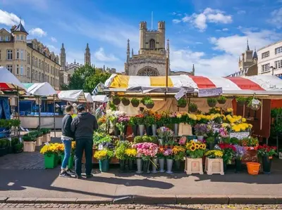 two people standing in front of a market with flowers at Spacious 3-Bed Townhouse Florence Villa Near River & City in Chesterton
