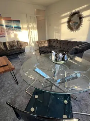 a glass coffee table in a living room with a couch at Salvation View 2 Bed Apartment in Hadleigh