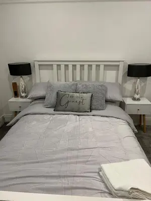 a bedroom with a large bed with two night stands at Salvation View 2 Bed Apartment in Hadleigh