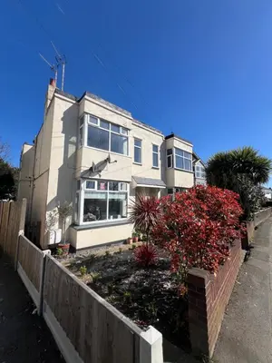 a white house with a fence in front of it at Salvation View 2 Bed Apartment in Hadleigh